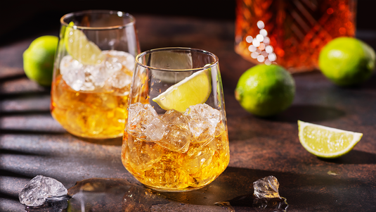 gold rum served over ice with a wedge of lime